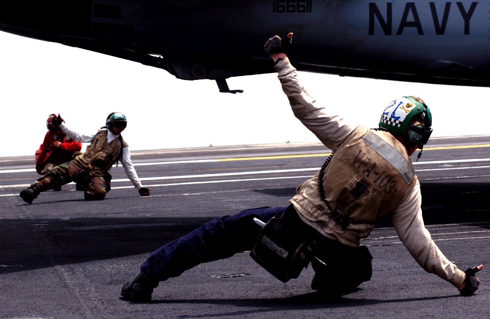 US Navy 070424-N-6854D-001 Troubleshooters from the Jolly Rogers of Strike Fighter Squadron (VFA) 103 give a thumbs up sign prior to launching an F-A-18F Super Hornet