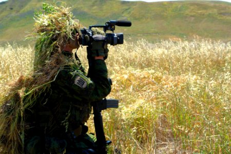 US Navy 070424-N-9643K-007 A combat videographer practices evasion techniques while on a mock patrol during Quick Shot 2007