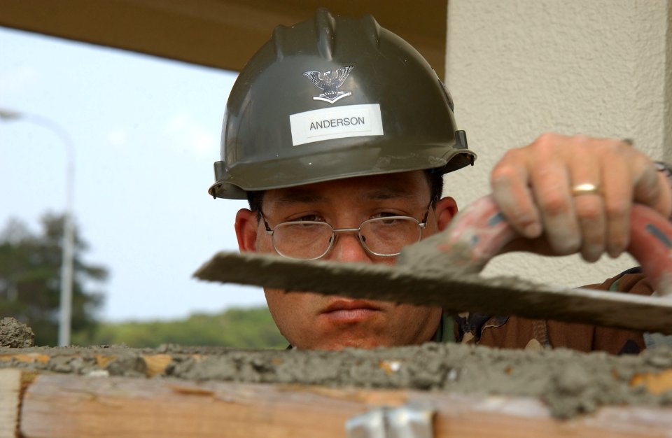 US Navy 070419-N-4198C-062 Engineering Aid 3rd Class Jon Anderson, a Seabee attached to Naval Mobile Construction Battalion (NMCB) 3, uses a magnesium float during the construction of a wall at Camp Shields