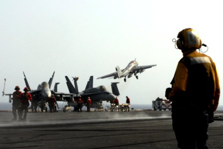 US Navy 070422-N-2659P-035 Aviation Boatswain's Mate 3rd Class Adrian Viscaino from the flight deck handling division observes the successful launch of an EA-6B Prowler