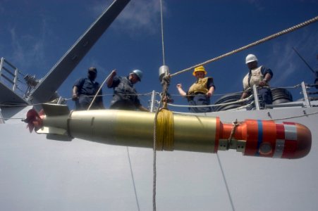 US Navy 070419-N-5253W-005 Sailors aboard the Arleigh Burke-class guided-missile destroyer USS Lassen (DDG 82) raise a practice torpedo from the water following a torpedo exercise