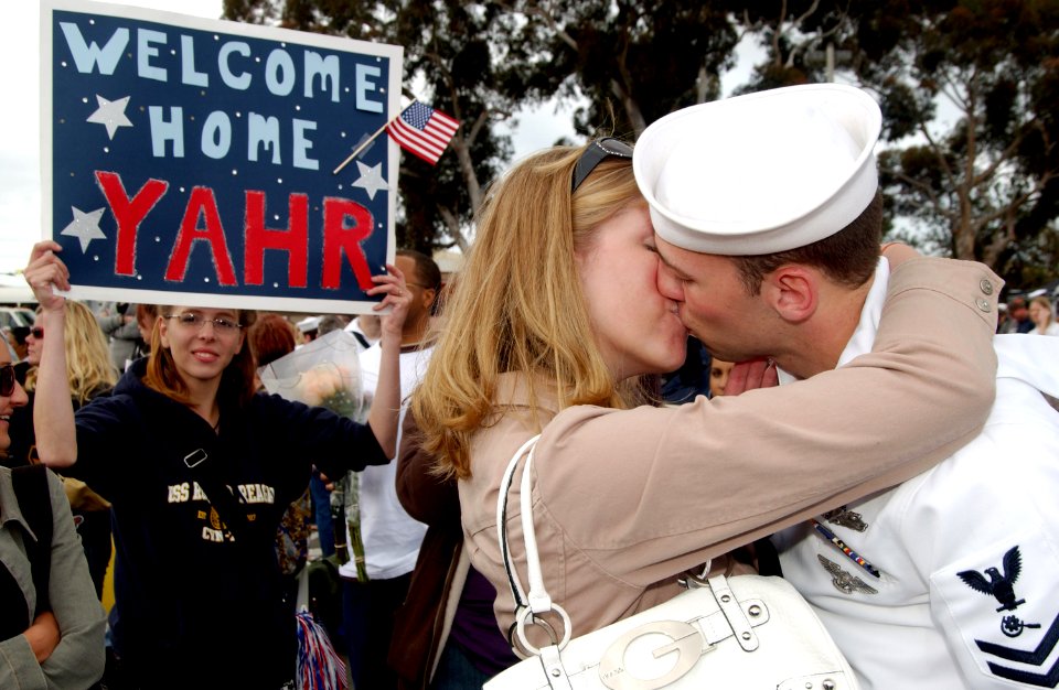 US Navy 070420-N-0555B-186 Machinery Repairman 2nd Class Brandon Yahr is welcomed home with a kiss after returning from a three-month deployment aboard USS Ronald Reagan (CVN 76)