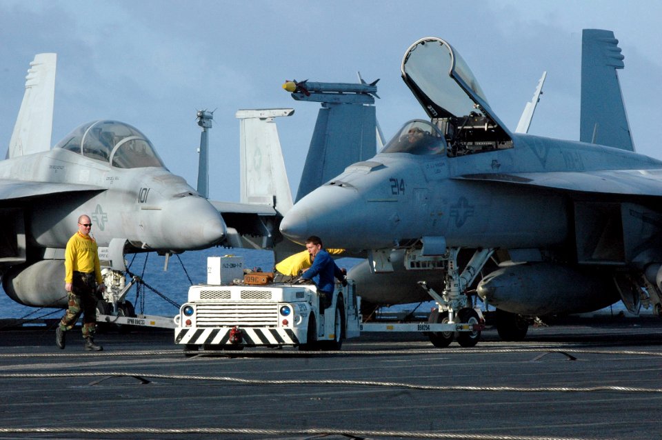US Navy 070424-N-7128A-271 Sailors move an aircraft on the flight deck during a no-fly day aboard nuclear-powered aircraft carrier USS Nimitz (CVN 68)