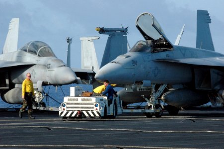 US Navy 070424-N-7128A-271 Sailors move an aircraft on the flight deck during a no-fly day aboard nuclear-powered aircraft carrier USS Nimitz (CVN 68)