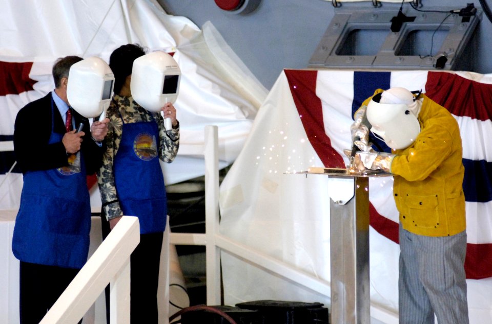 US Navy 070430-N-8467N-001 General Dynamics Electric Boat welder Kevin Cullen welds the sponsor's initials into a metal plate for the boat during the keel laying ceremony