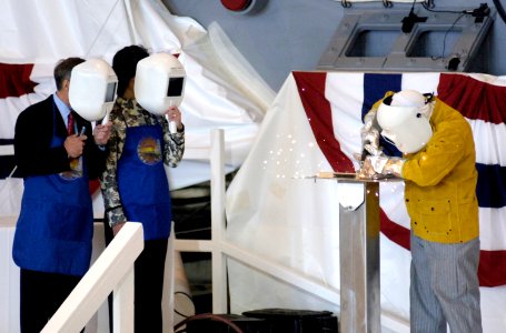 US Navy 070430-N-8467N-001 General Dynamics Electric Boat welder Kevin Cullen welds the sponsor's initials into a metal plate for the boat during the keel laying ceremony