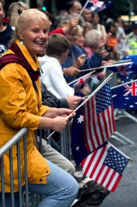 US Navy 070425-N-5253W-002 An Australian woman waves American and Australian flags as USS Lassen (DDG 82) Sailors march by during the Australia-New Zealand Army Corps (ANZAC) Day Parade