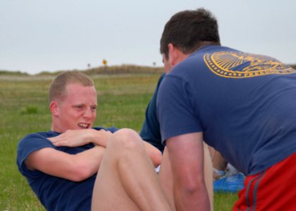 US Navy 070426-N-4459K-077 Machinist's Mate Fireman Bradley S. Sherrod performs sit-ups as part of PCU George H.W. Bush (CVN 77) 2007 Spring Physical Fitness Assessment photo