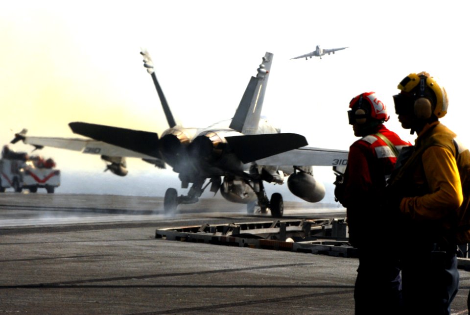 US Navy 070422-N-2659P-055 Aviation Ordnanceman Airman Cameron Sanchez, left, and Aviation Boatswain's Mate 3rd Class Adrian Viscaino observe the successful launch of an F-A-18C Hornet