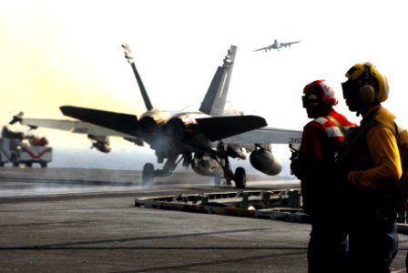 US Navy 070422-N-2659P-055 Aviation Ordnanceman Airman Cameron Sanchez, left, and Aviation Boatswain's Mate 3rd Class Adrian Viscaino observe the successful launch of an F-A-18C Hornet