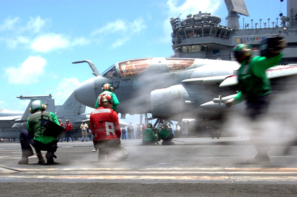 US Navy 070423-N-0890S-070 Flight deck Sailors perform last-minute checks on an EA-6B Prowler, assigned to the Black Ravens of Tactical Electronic Warfare Squadron (VAQ) 135, prior to launch aboard nuclear-powered aircraft carr