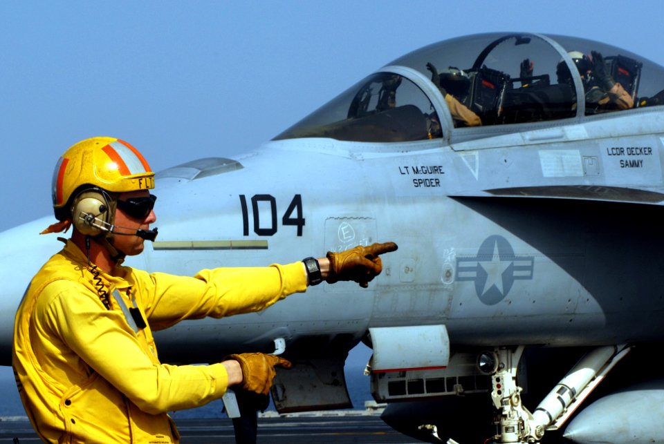 US Navy 070422-N-2659P-085 Lt. Eric Harrington, from air department's aircraft handling division, directs an F-A-18F Super Hornet from the Black Knights of Strike Fighter Squadron (VFA) 154