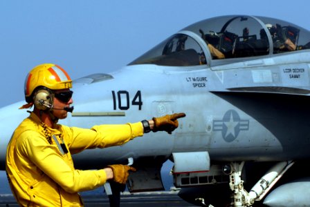 US Navy 070422-N-2659P-085 Lt. Eric Harrington, from air department's aircraft handling division, directs an F-A-18F Super Hornet from the Black Knights of Strike Fighter Squadron (VFA) 154