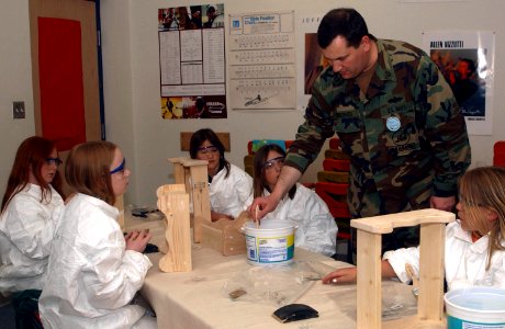 US Navy 070427-N-2143T-005 Chief Construction Electrician Mark Thresher assigned to Naval Facilities Engineering Command teaches kids at East Port Orchard Elementary school how to properly use a paint brush