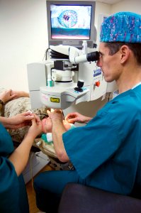 US Navy 070501-N-5319A-007 Capt. Joseph Pasternak, an ophthalmology surgeon at National Naval Medical Center Bethesda, lines up the laser on Marine Corps Lt. Col. Lawrence Ryder's eye before beginning LASIK IntraLase surgery