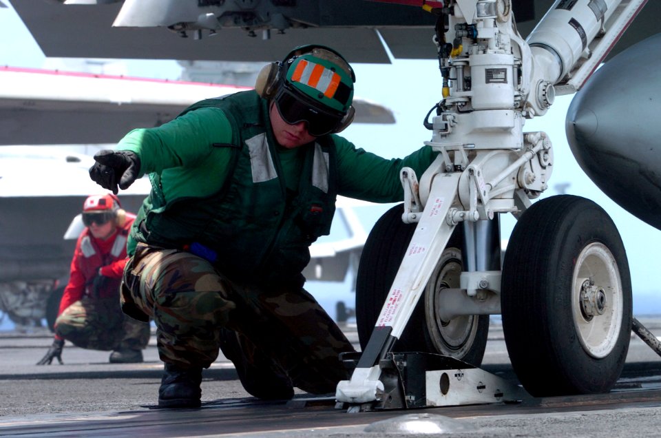 US Navy 070423-N-4420S-043 Aviation Boatswain's Mate Equipment 3rd Class Josh Stonestreet signals to send the catapult forward to prepare an F-A-18C Hornet for launch aboard nuclear-powered aircraft carrier USS Nimitz (CV