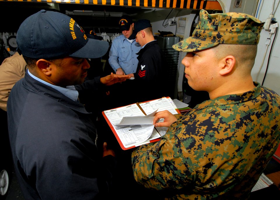 US Navy 070424-N-7981E-069 Marine Sgt. Jesus R. Rivera, a quality assurance representative (QAR) from Fleet Readiness Center (FRC) Northwest, reviews maintenance history records