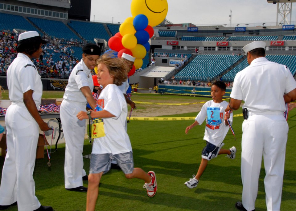 US Navy 070428-N-1522S-027 Naval Station Mayport Sailors pass out medals to children participating in the Let Us Play 2k Run at the Jacksonville Municipal Stadium