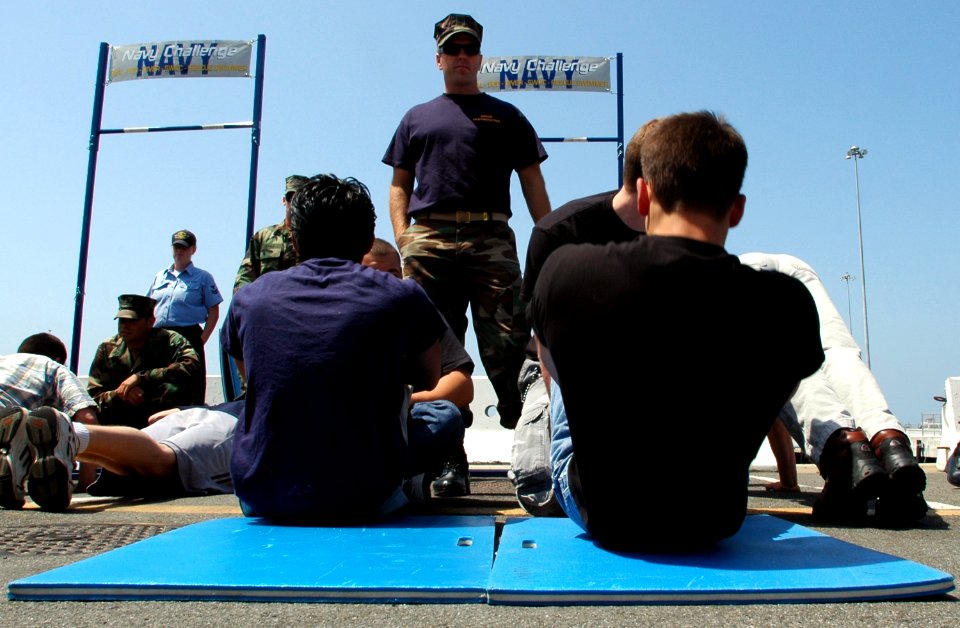 US Navy 070426-N-4163T-143 Members of the Navy's Delayed Entry Program (DEP) perform as many sit-ups as they can within a two-minute time limit while being watched by a Naval Special Warfare (NSW) Center motivator