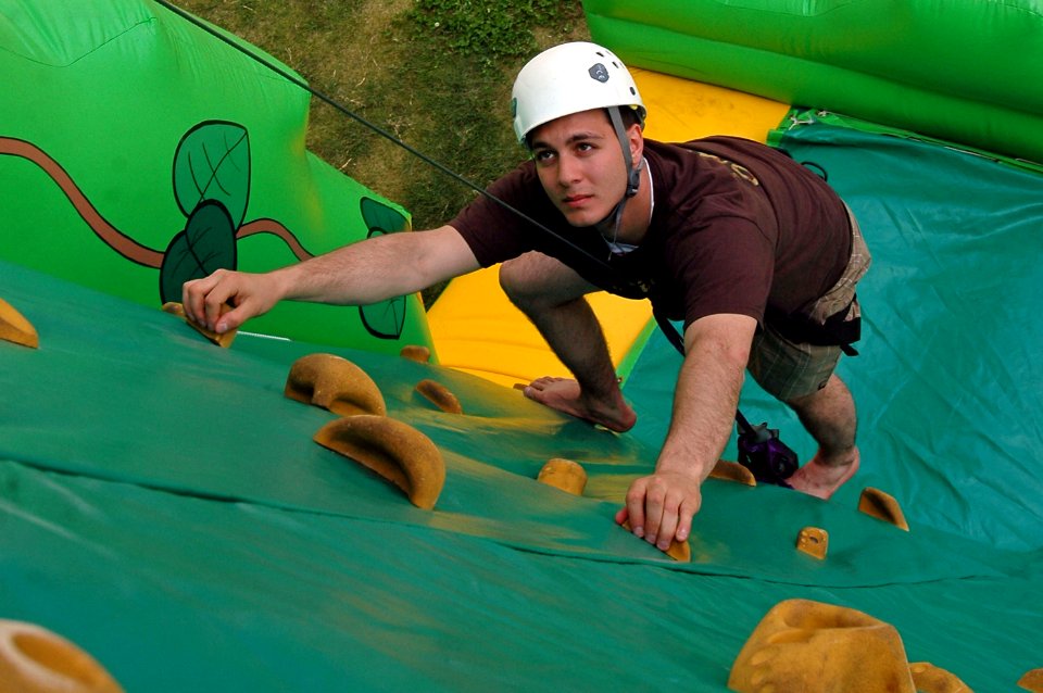 US Navy 070427-N-7883G-065 Aerographer's Mate 3rd Class Kristopher Rodriguez, from Baltimore, climbs an inflatable rock wall during USS Kitty Hawk's (CV 63) 46th birthday party and picnic