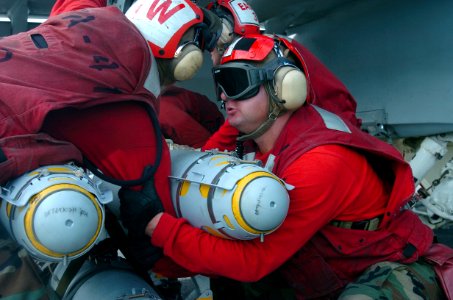 US Navy 070426-N-4420S-085 Aviation Ordnanceman 3rd Class Joshua Cox, assigned to the Black Aces of Strike Fighter Squadron (VFA) 41, prepares to load ordnance onto an F-A-18E Super Hornet aboard nuclear-powered aircraft carrie