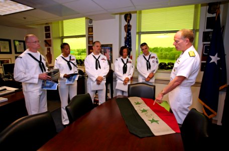 US Navy 070503-N-5386H-026 Commander, Navy Reserve Force, Vice Adm. John G. Cotton, explains the meanings and origins of the details on the flag of Irag to the Reserve Sailor of the Year (SOY) finalists during a Pentagon visit photo