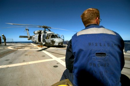 US Navy 070430-N-5253W-001 Seaman Jeremy Stoker, of Arleigh Burke-class guided missile destroyer USS Lassen (DDG 82), prepares to help launch an SH-60B helicopter photo