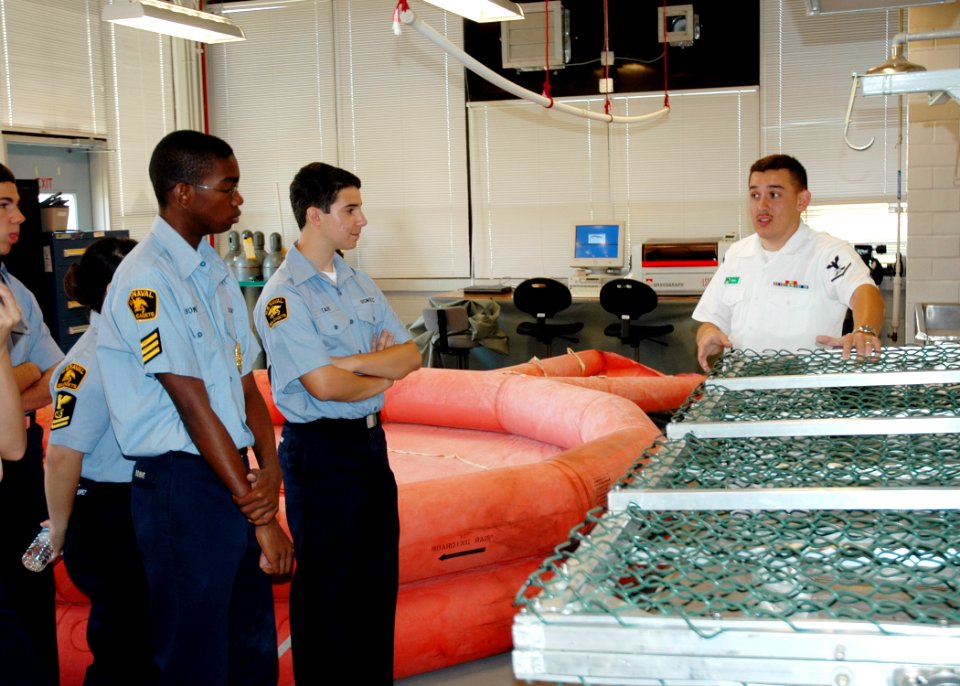 US Navy 070430-N-7427G-001 Aircrew Survival Equipmentman Shawn Parra demonstrates various life-saving gear during a visit by the Eisenhower Sea Cadet Unit from Avondale, La