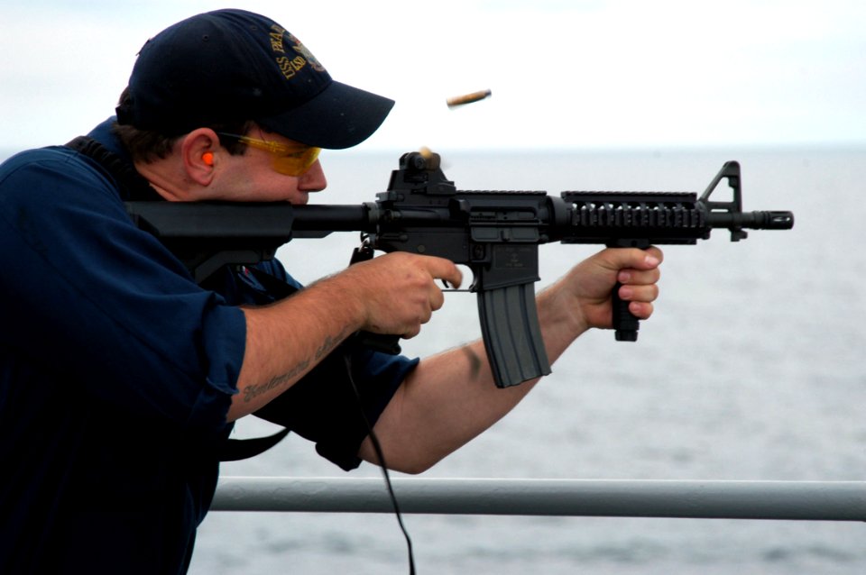 US Navy 070501-N-7029R-035 Gunner's Mate 3rd Class Louie Mitts shoots an M-16 during a weapons exercise on board USS Pearl Harbor (LSD 52)