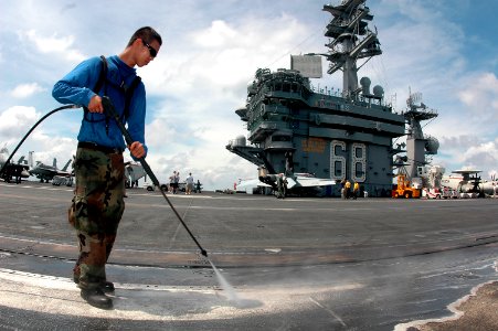 US Navy 070501-N-9760Z-033 Aviation Boatswain's Mate Handling Airman Philip Baker uses a pressure washer to clean the flight deck