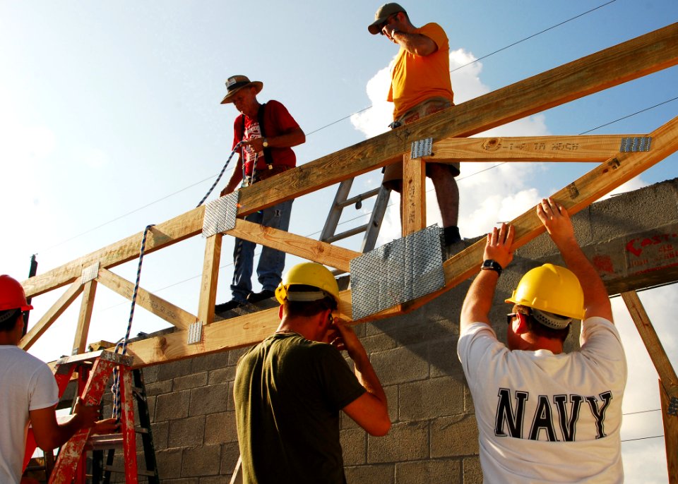 US Navy 070503-N-1831S-038 Sailors from the Kearsarge Expeditionary Strike Group and local Fort Lauderdale volunteers work together to lift a roofing frame