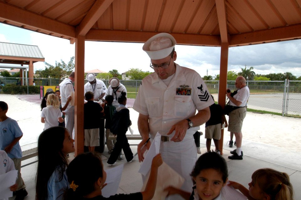 US Navy 070503-N-5033P-277 Operations Specialist 1st class Jerald L. Anderson signs autographs for the children at a local elementary school in Broward County as a part of Fleet Week in Fort Lauderdale