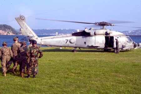 US Navy 070502-N-0483B-003 Marines from the Fleet Antiterrorism Security Team (FAST) work with Navy explosive ordnance disposal technicians (EOD) from EOD Mobile Unit 5 photo