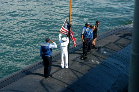 US Navy 070504-N-7955L-298 Sailors assigned to fast attack submarine USS Memphis (SSN 691) lower the ensign before departing Port Everglades