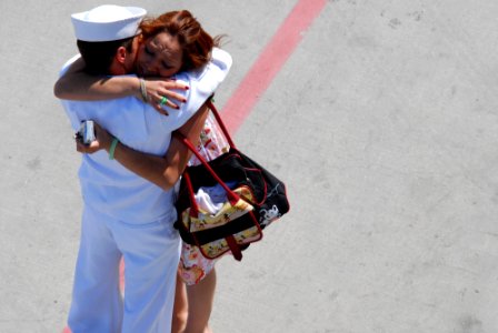 US Navy 070503-N-8273J-214 Seaman Brandon Tomason is welcomed home with a kiss by his wife, during a homeport arrival ceremony for the crew members of USS New Orleans (LPD 18) at Naval Base San Diego