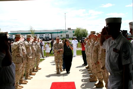 US Navy 070508-N-0975R-003 The wife of Electrician's Mate 1st Class Charles Komppa and Utilitiesman 1st Class J Williamson enter Navy Operational Support Center Billings for the first time after officially bearing the nam