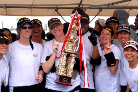 US Navy 070505-N-0775Y-055 Seabees from Naval Mobile Construction Battalion (NMCB) 3 and other members of the Navy women's dragon boat team cheer after winning first place over the Army, Air Force and Marines during the a