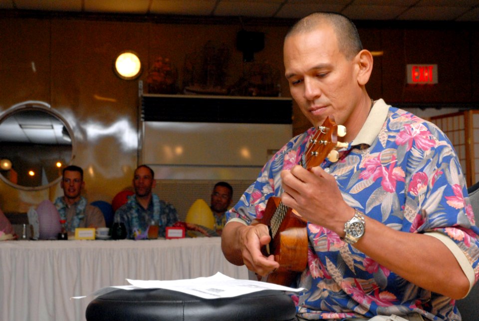 US Navy 070504-N-0775Y-057 Chief Equipment Operator Sean Martin, a Seabee attached to Naval Mobile Construction Battalion (NMCB) 3, plays his Hawaiian ukulele during the Asian Pacific American Heritage celebration