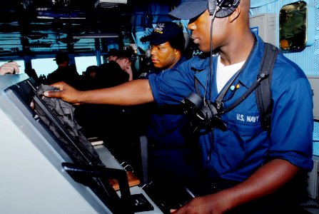 US Navy 070505-N-5484G-001 Boatswain's Mate Seaman Brandon Wildman stands watch as helm controlman aboard nuclear-powered aircraft carrier USS Nimitz (CVN 68)