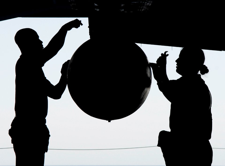 US Navy 070507-N-3729H-019 Aviation Ordnanceman 2nd Class Dusty Turner (left) and Aviation Ordnanceman 3rd Class Rodd Wallace secure the mounts on a fuel drop tank