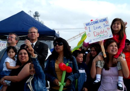 US Navy 070503-N-9604C-003 Families and friends of Sailors aboard USS New Orleans (LPD 18), gather on the pier at Naval Base San Diego to greet the Sailors as the ship makes its arrival in its new homeport