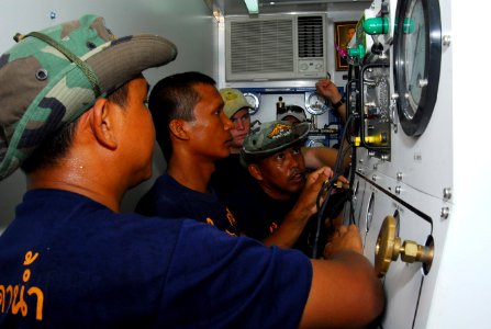 US Navy 070509-N-4124C-057 Royal Thai Navy divers and U.S. Navy divers assigned to Explosive Ordnance Disposal Mobile Unit (EODMU) 5 practice procedures on a compression chamber during Cobra Gold 2007
