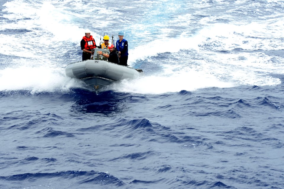 USS Dewey rigid-hull inflatable boat team approaches USS Bunker Hill 140922-N-GW918-172