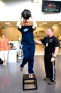 US Navy 070509-N-5319A-011 Chief Engineman Peter Johns performs rehab exercises while his mother watches in the Center for the Intrepid aboard Brooke Army Medical Center