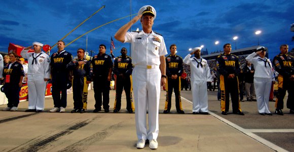 US Navy 070504-N-5345W-273 Chief of Naval Operations Deputy for Combat Systems and Weapons, Rear Adm. Nevin Carr, renders honors along with the U.S. Navy ^88 Chevy Monte Carlo team and Navy recruiters from Recruiting District R