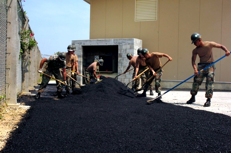 US Navy 070510-N-4198C-011 Seabees assigned to Naval Mobile Construction Battalion (NMCB) 3, spread asphalt during the construction of a parking lot at Kadena Air Force Base