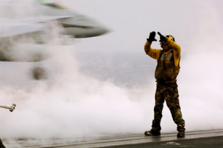 US Navy 070506-N-5330L-002 A plane director signals to the pilot of an F-A-18C Hornet, from the