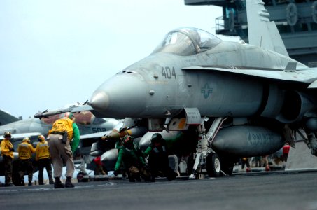 US Navy 070511-N-4420S-223 Chief Aviation Boatswain's Mate Equipment Andre Walton checks to make sure the launch bar is securely fastened on the catapult before signaling to launch the F-A-18C Hornet