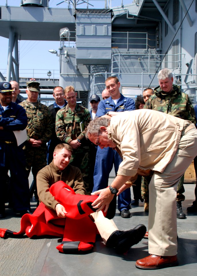 US Navy 070508-N-6544L-001 Embarked Joint Forces Maritime Component Command Europe (JFMCC-EUR) staff watch as Lt. Cmdr. Mark Kloster, with the help of Mount Whitney shipboard personnel, demonstrates donning a Gumby