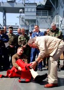 US Navy 070508-N-6544L-001 Embarked Joint Forces Maritime Component Command Europe (JFMCC-EUR) staff watch as Lt. Cmdr. Mark Kloster, with the help of Mount Whitney shipboard personnel, demonstrates donning a Gumby